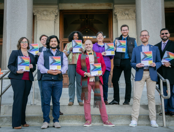 NHPC Executive Director and Members of the LGBTQ+ Health & Human Service Network pose with the 2021 LGBTQ+ Needs Assesment Survey